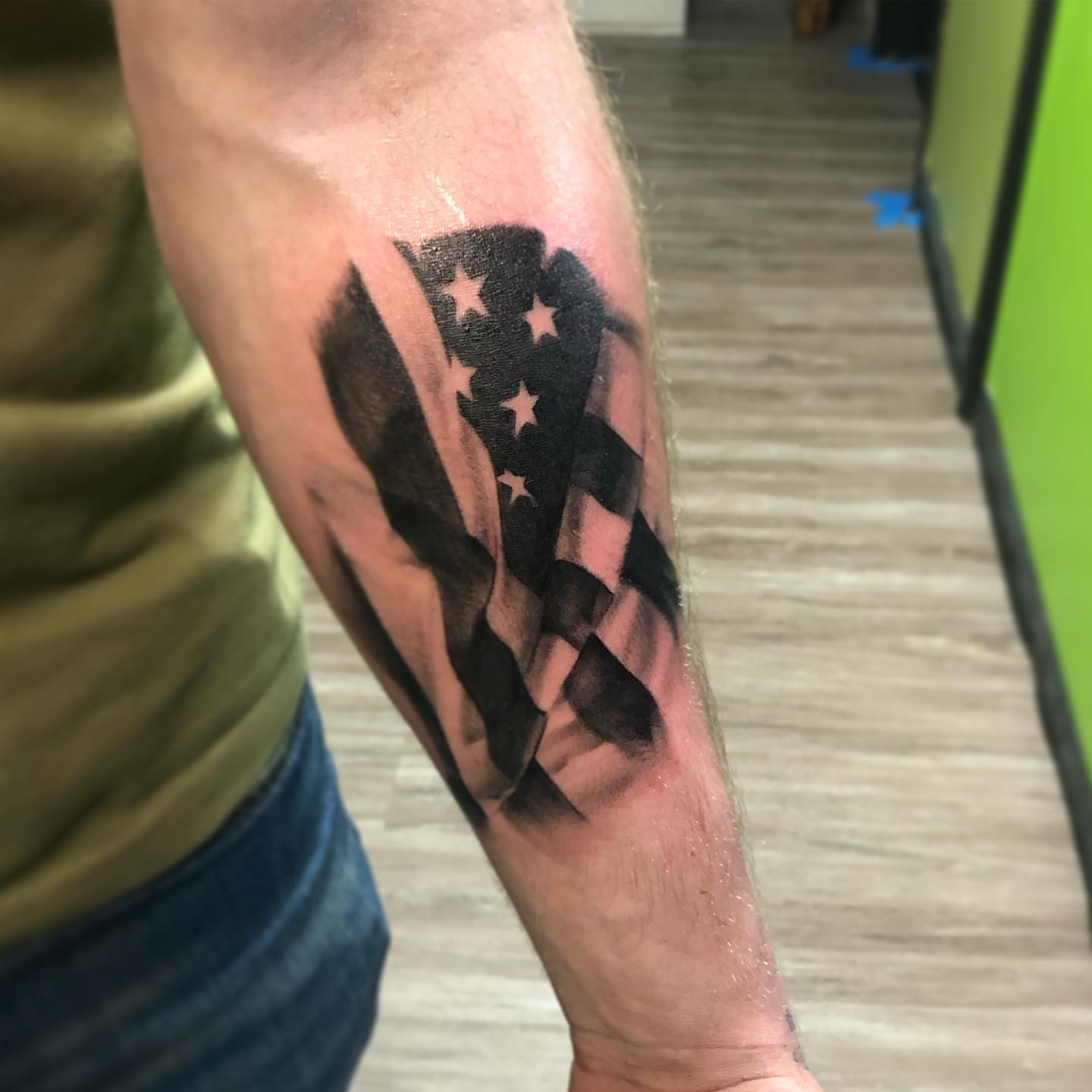 American flag black and grey tattoo on the forearm by Nick Jones (Buttonsandfaders)