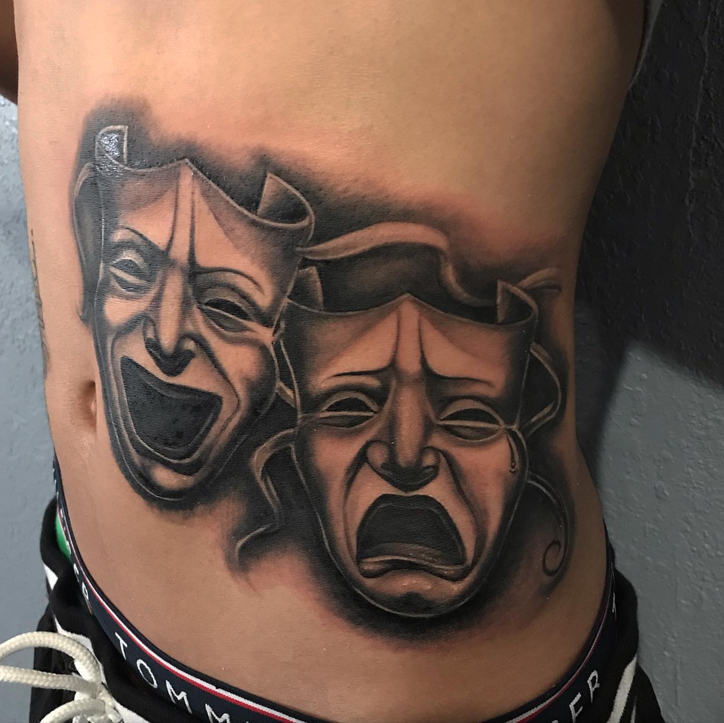 Theater masks realism tattoo on the ribs by Jayjay🦅