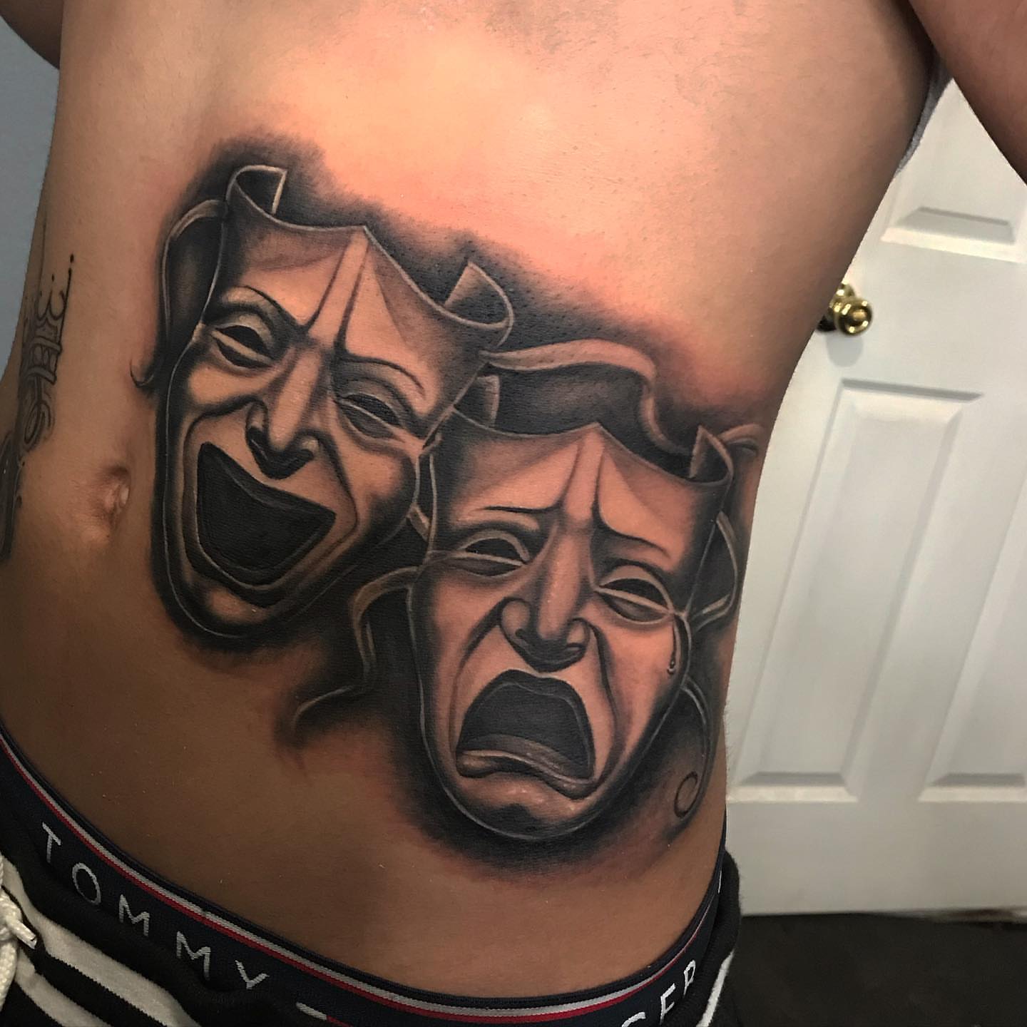Theater masks realism tattoo on the ribs by Jayjay🦅