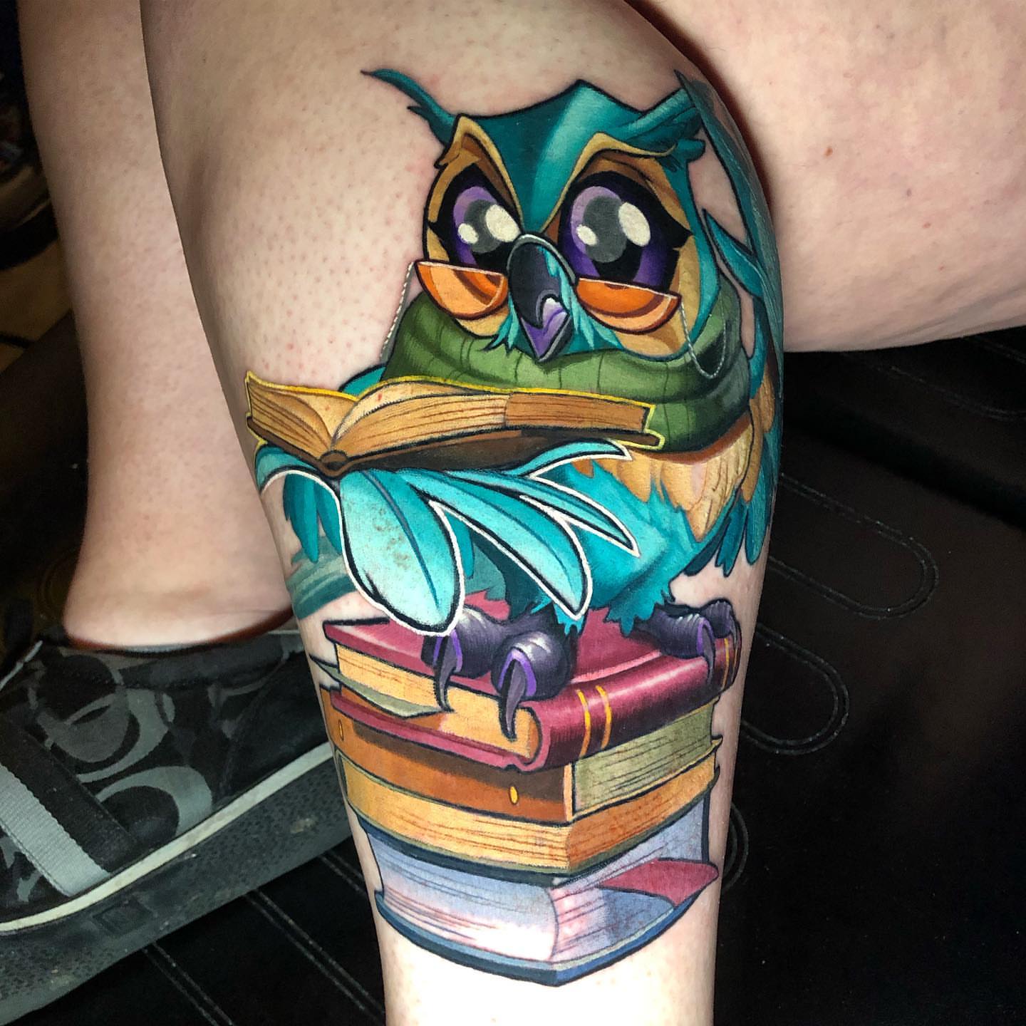 Owl reading books new school tattoo on the thigh by Tim Stafford