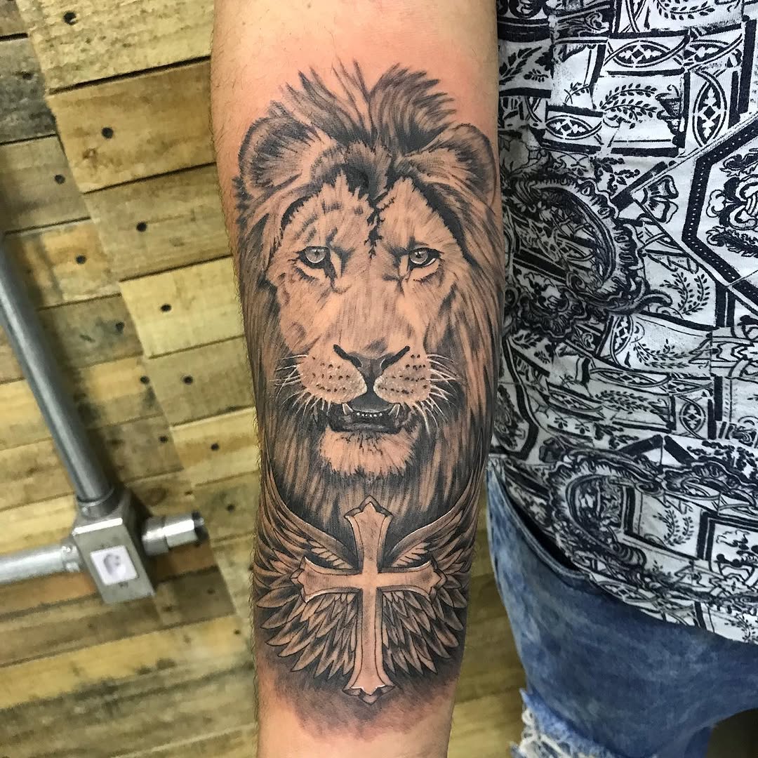 Lion head with cross and wings Chicano tattoo on the forearm by PrimaTa’ttoo_021
