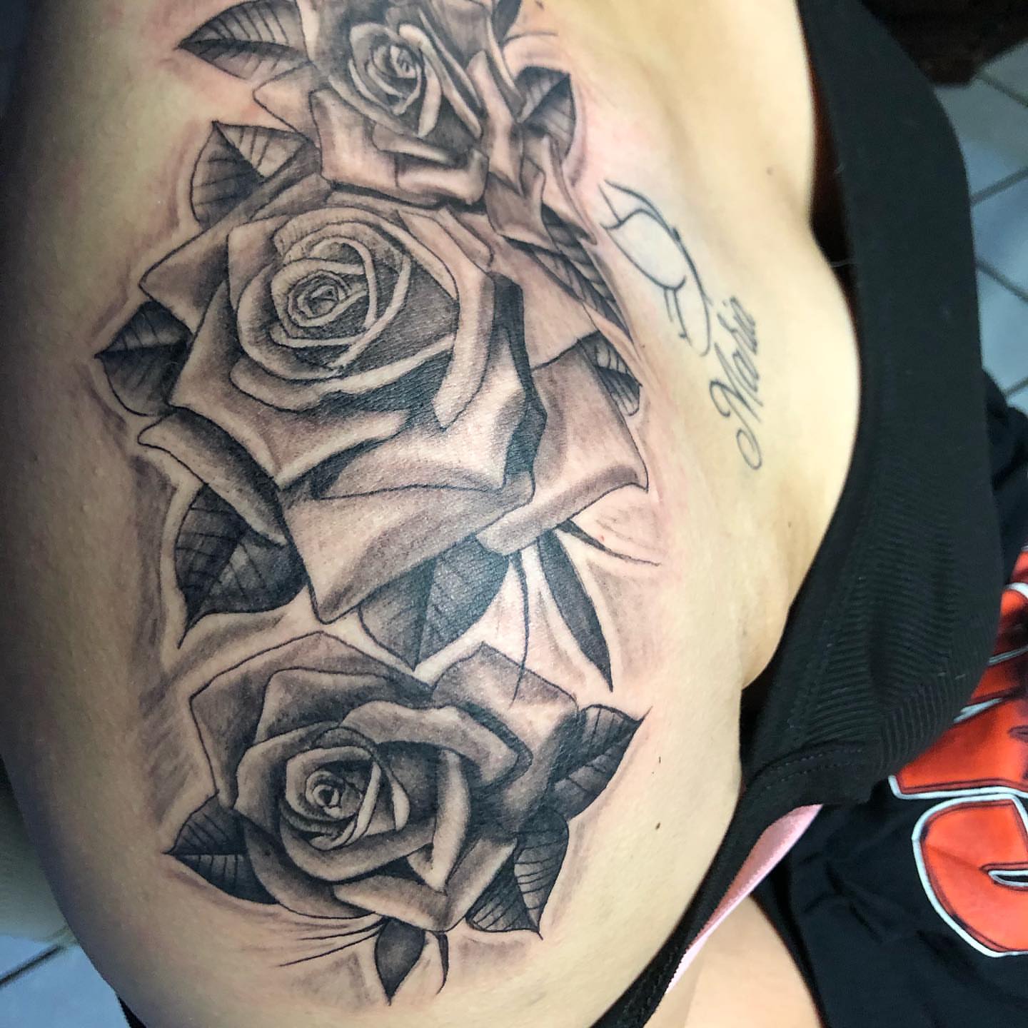 Roses realism tattoo on the thigh by Junior Trevino