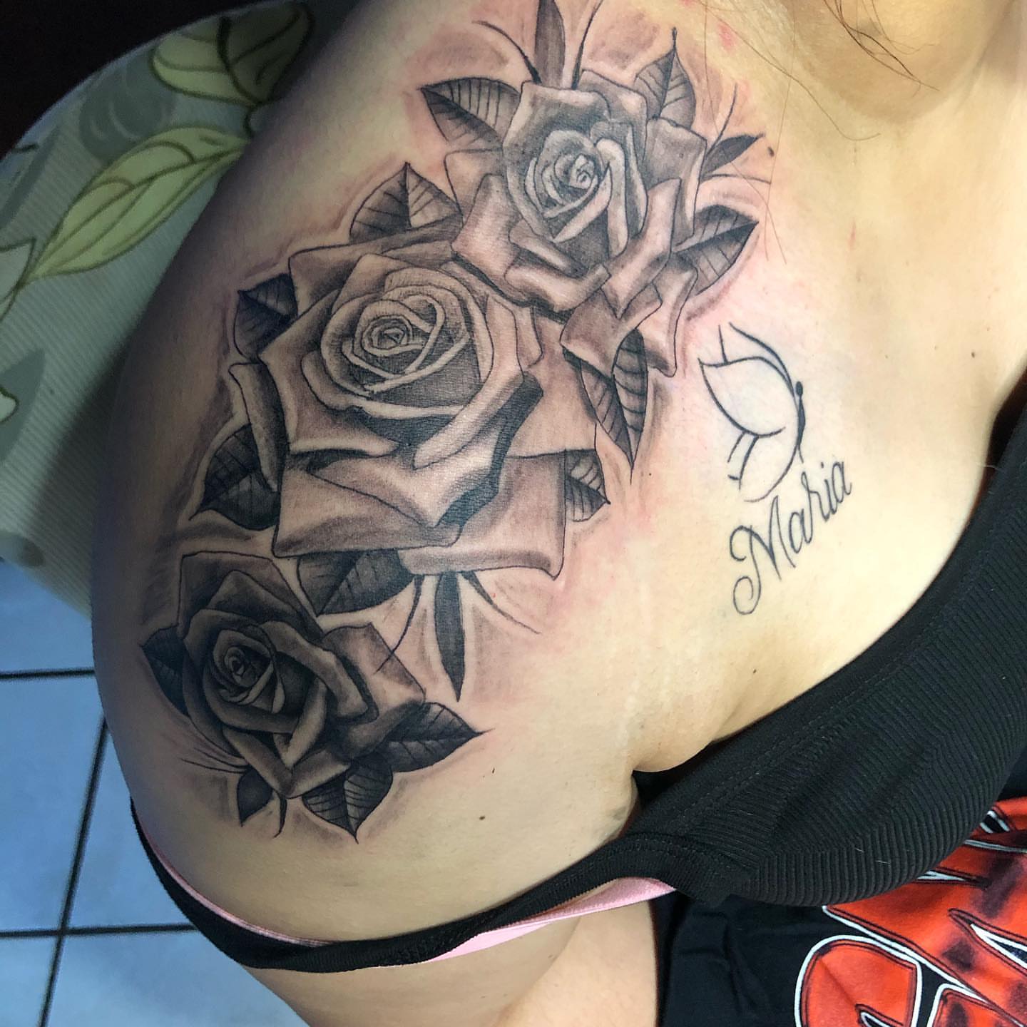 Roses black and grey tattoo on the chest by Junior Trevino
