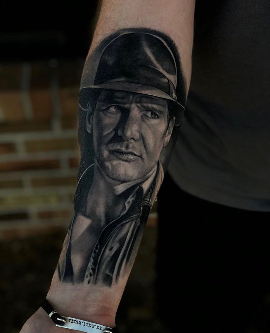 Indiana Jones portrait realism tattoo on the forearm by @kotytattoos