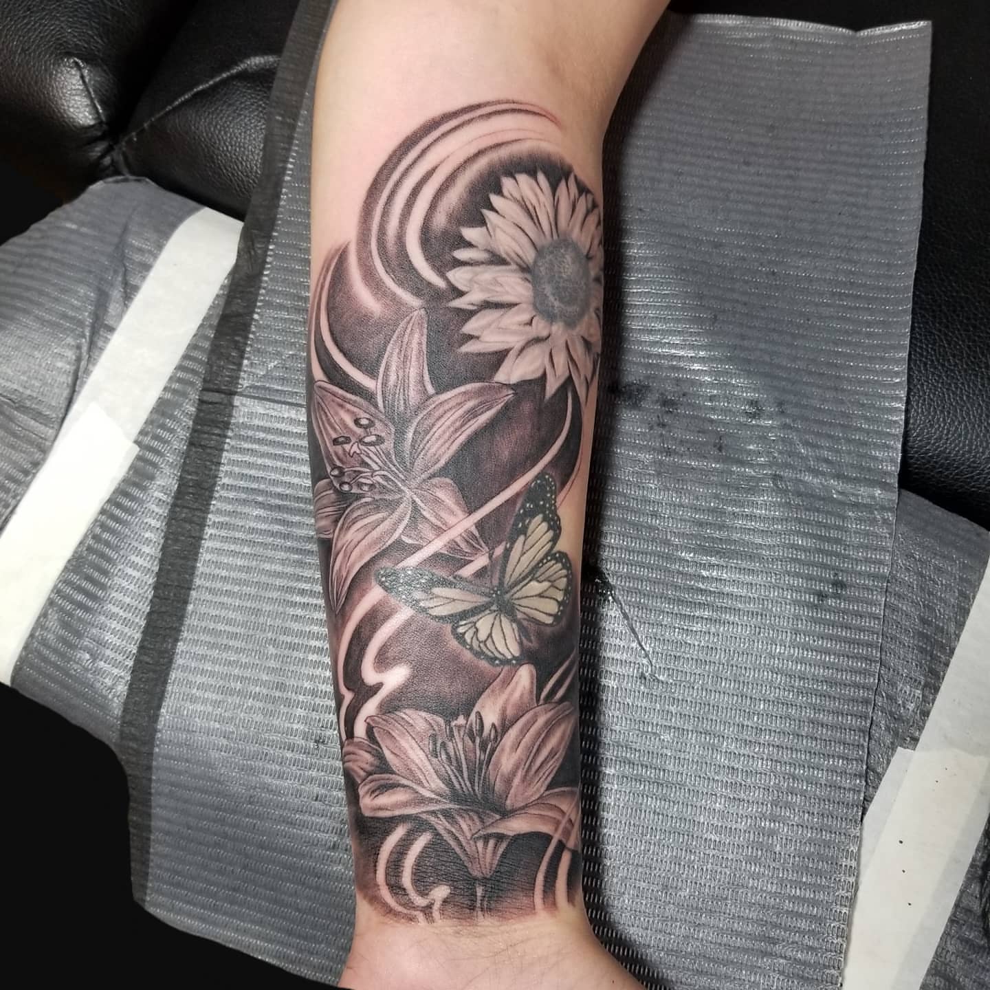 Flowers and butterfly realism tattoo on the forearm by Miguel-C, Houston, Texas