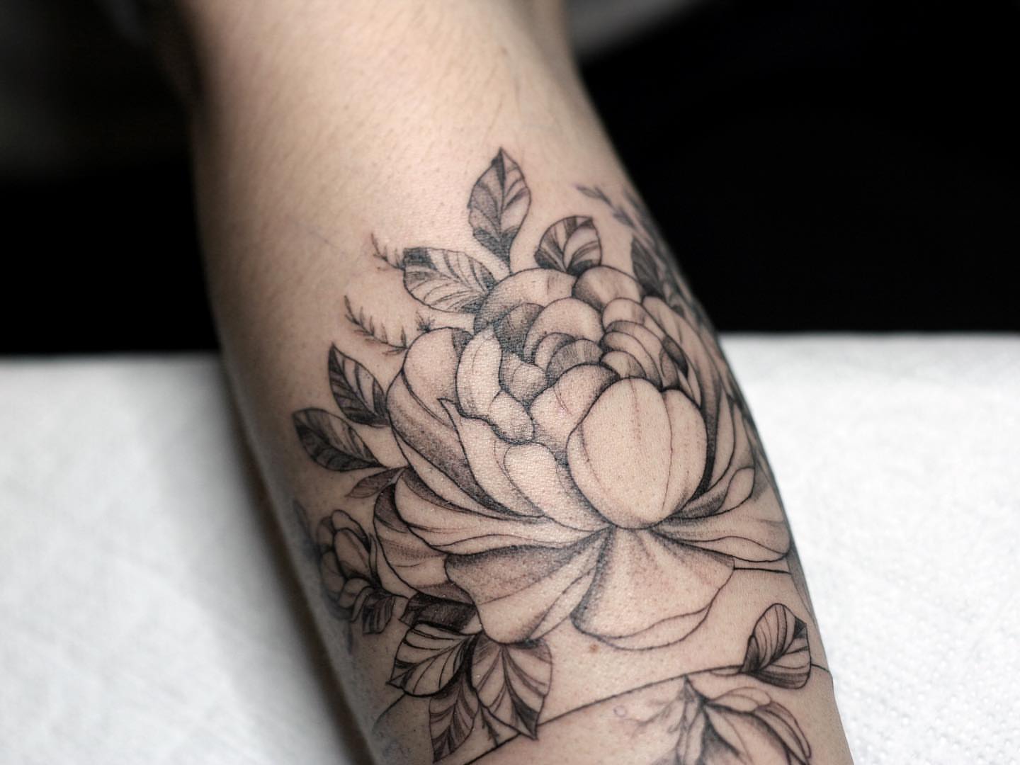 Flower black and grey tattoo on the forearm by Tattoo San Diego