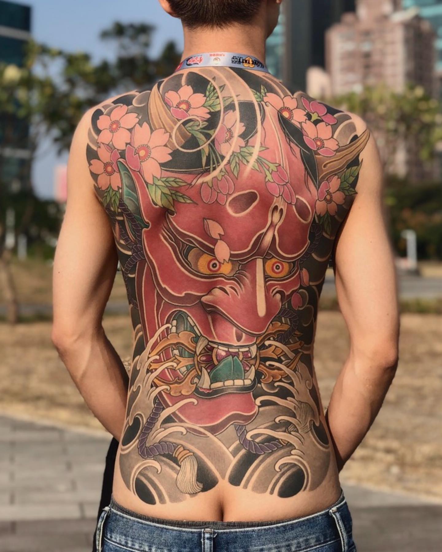 Demon mask with cherry blossoms japanese irezumi tattoo on the back by 重君
