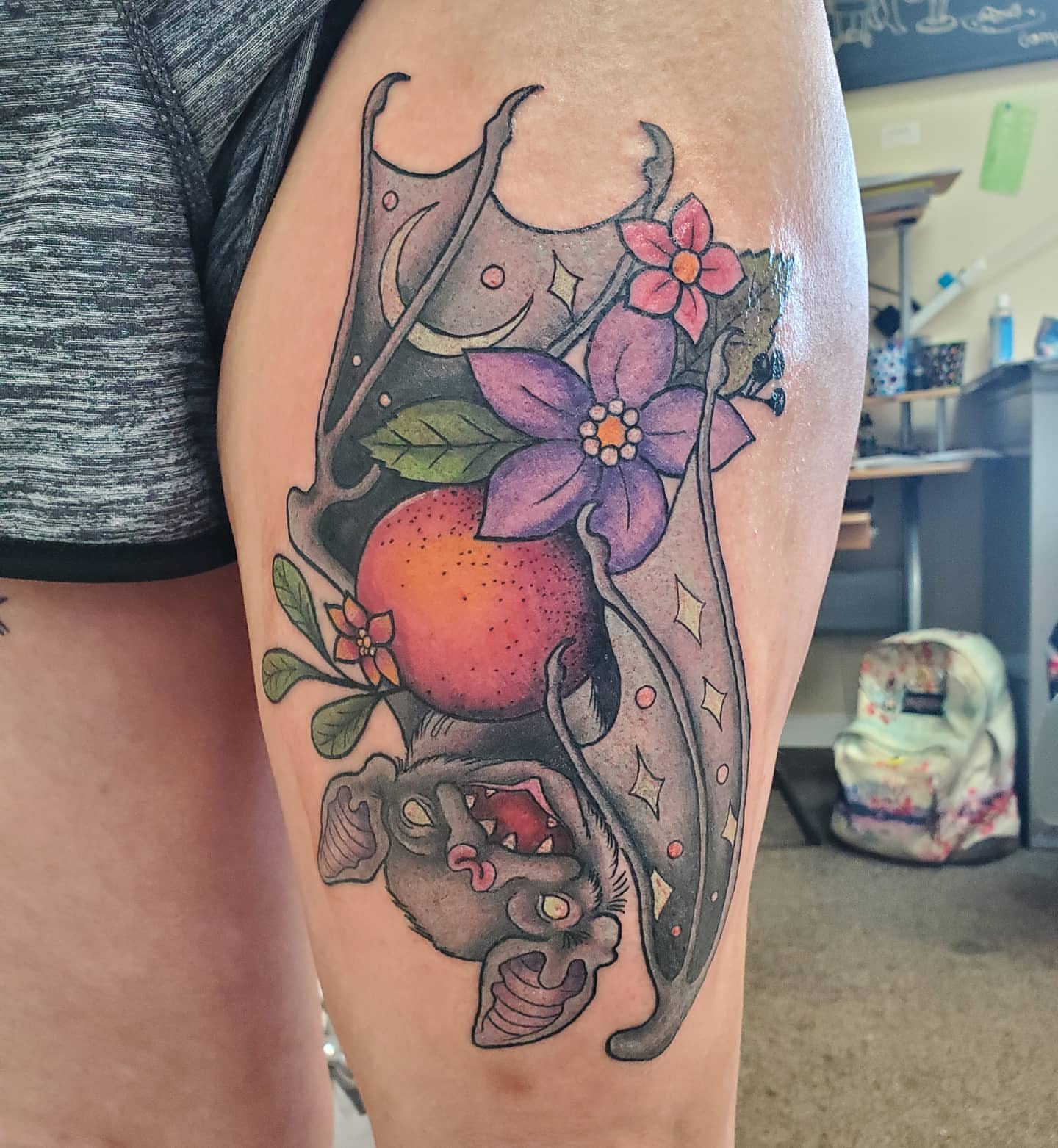 Fruit and flowers American traditional tattoo on the thigh by Ginny McCormick, Richmond, Virginia