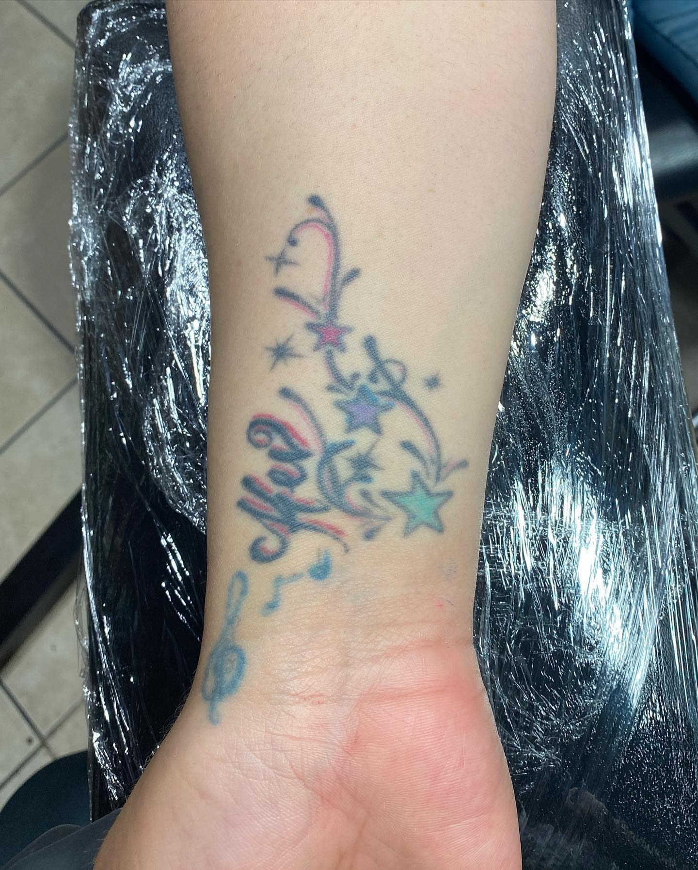 Music notes and stars new school tattoo on the forearm by "el asere, el zurdo"