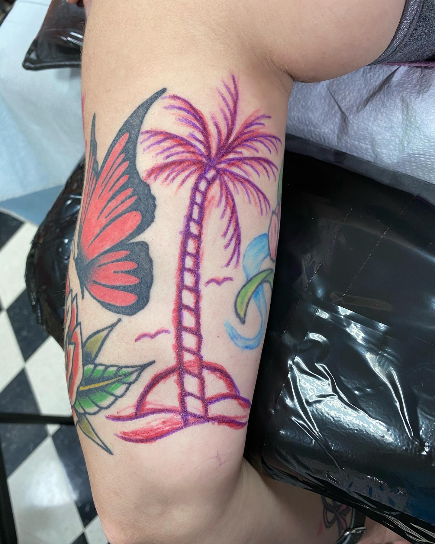 Palm tree and butterfly American traditional tattoo on the forearm by Jake Snoddy, Franklin, Tennessee