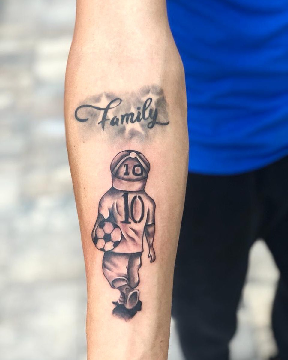 Soccer player black and grey tattoo on the forearm by Kevin Palma
