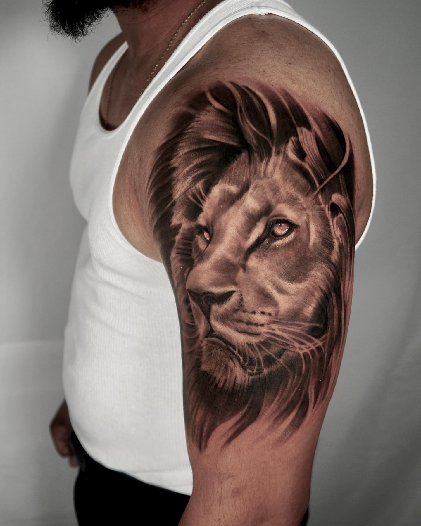 Lion realism tattoo on the upper arm by ๐ฝ๐๐๐๐๐๐๐ ๐ถ๐๐๐
