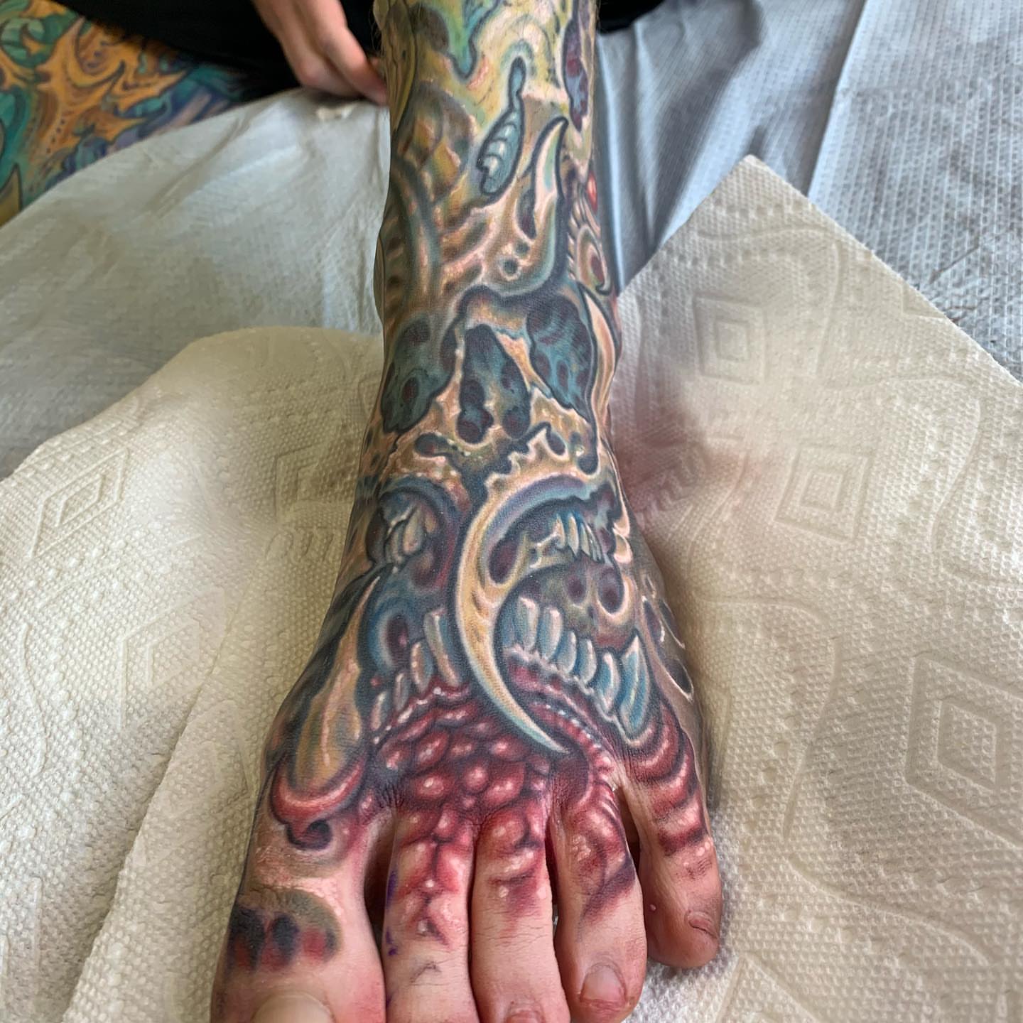 Screaming skull dark realism tattoo on the foot by Phil Robertson