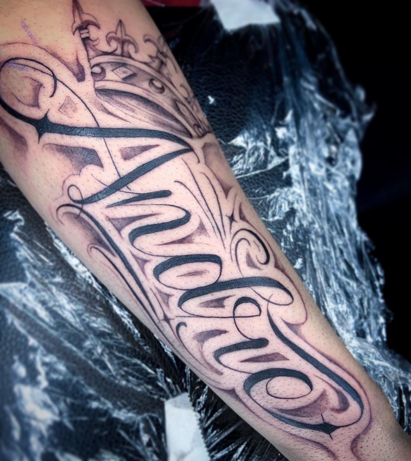 Script lettering black and grey tattoo on the forearm by Nj Tattoo Artist Inkdyou, Bloomfield, New Jersey