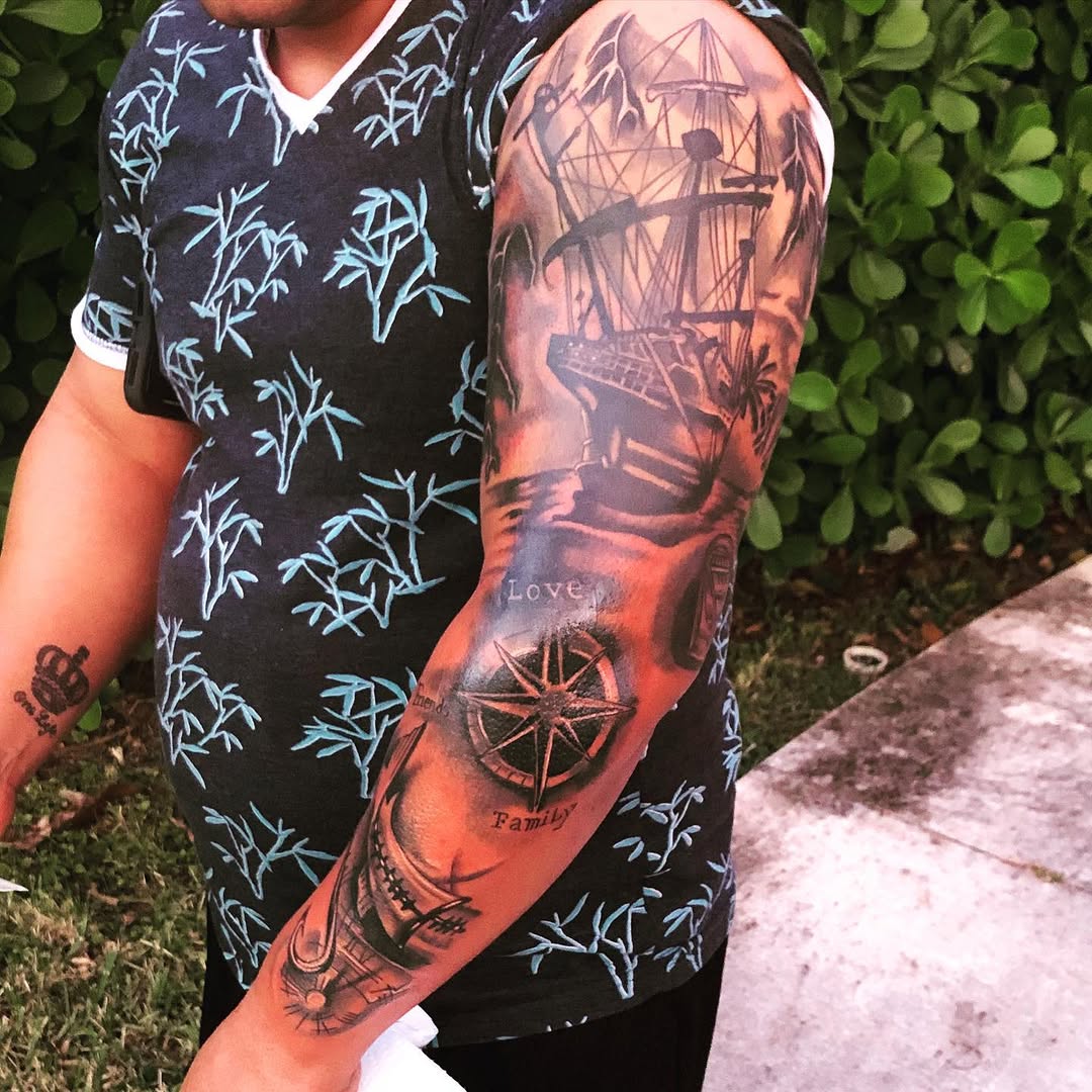 Ship and compass tattoo on the upper arm by Tattoos By Mauze