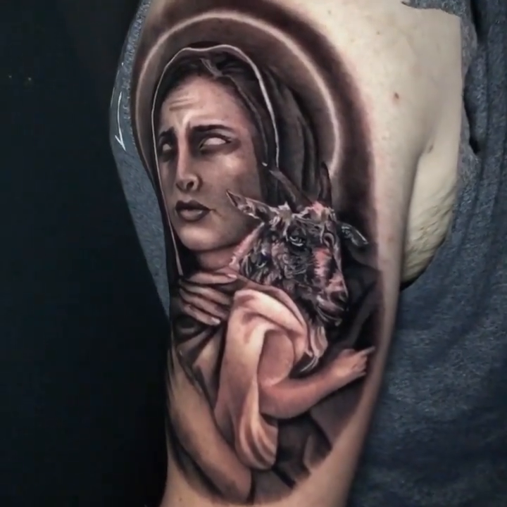 A sorrowful woman holding a lamb realism tattoo by Travis Chick