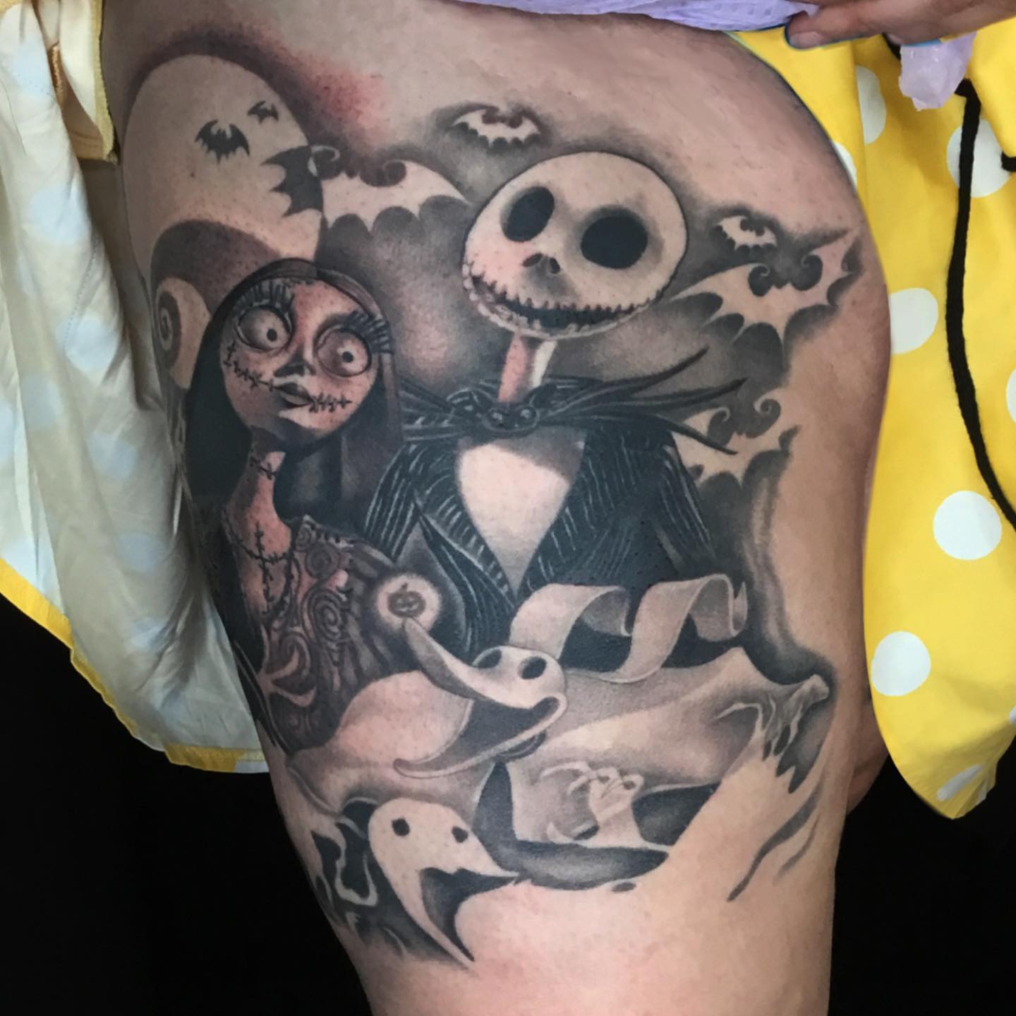 Jack and Sally dark realism tattoo on the thigh by Ariel Robinson