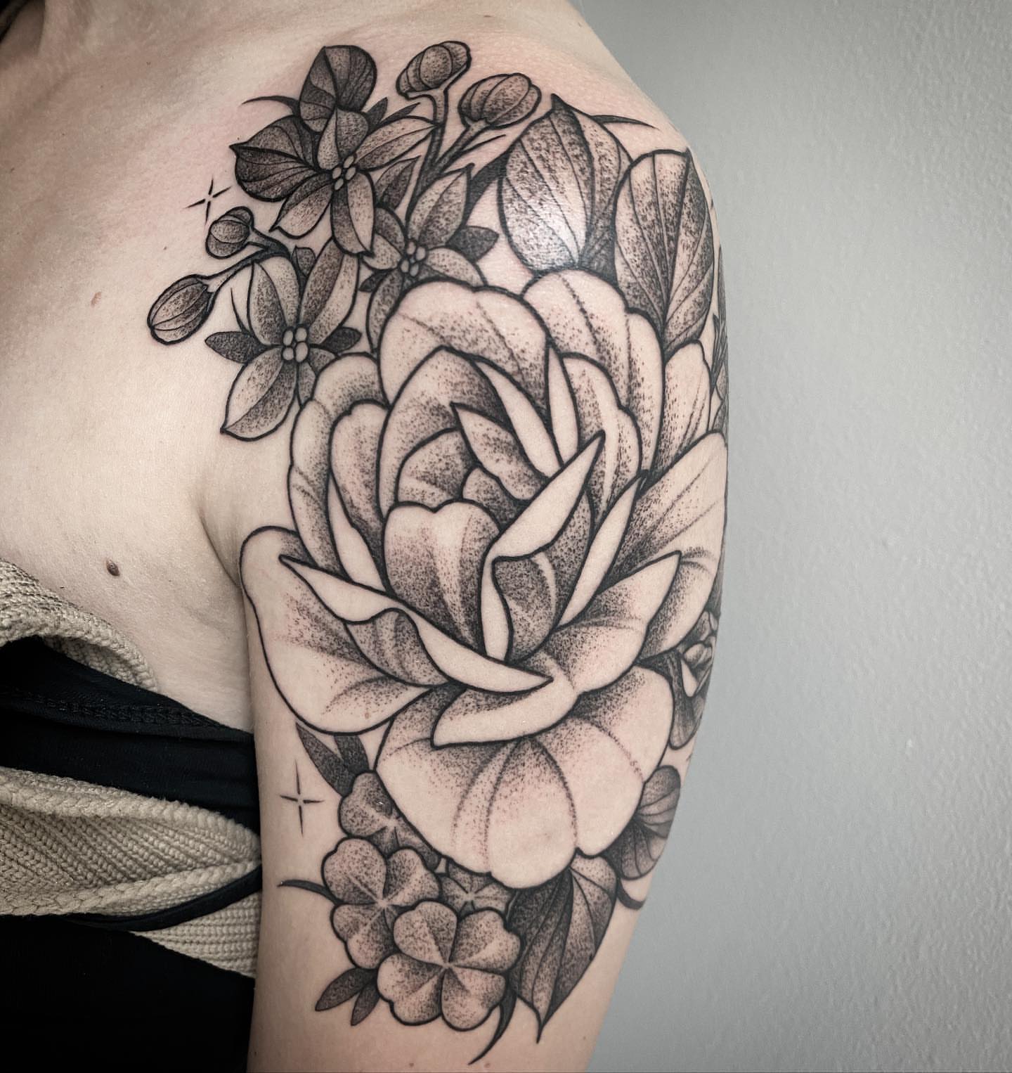 Flower bouquet dotwork tattoo on the shoulder by Dale DeVille