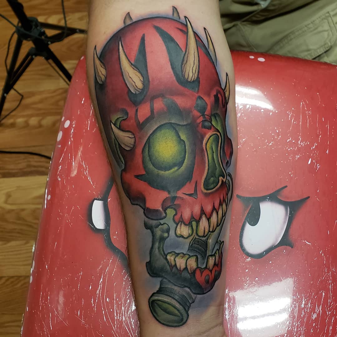 Skull with gas mask American traditional tattoo on the forearm by Don Taylor