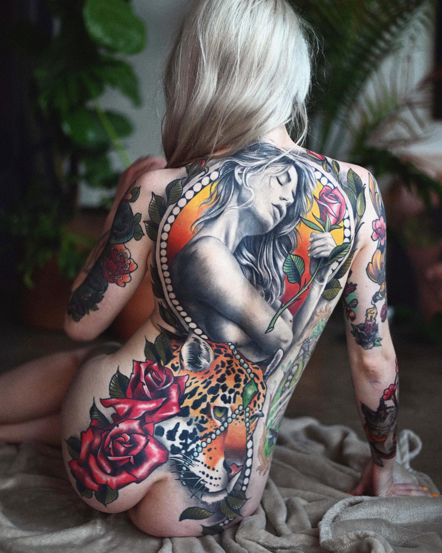 Woman with roses and leopard American traditional tattoo on the back by Lorenzo Lopez