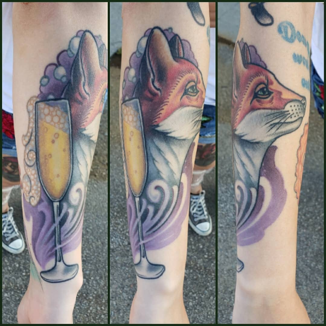Fox and champagne flute American traditional tattoo on the forearm by Don Taylor