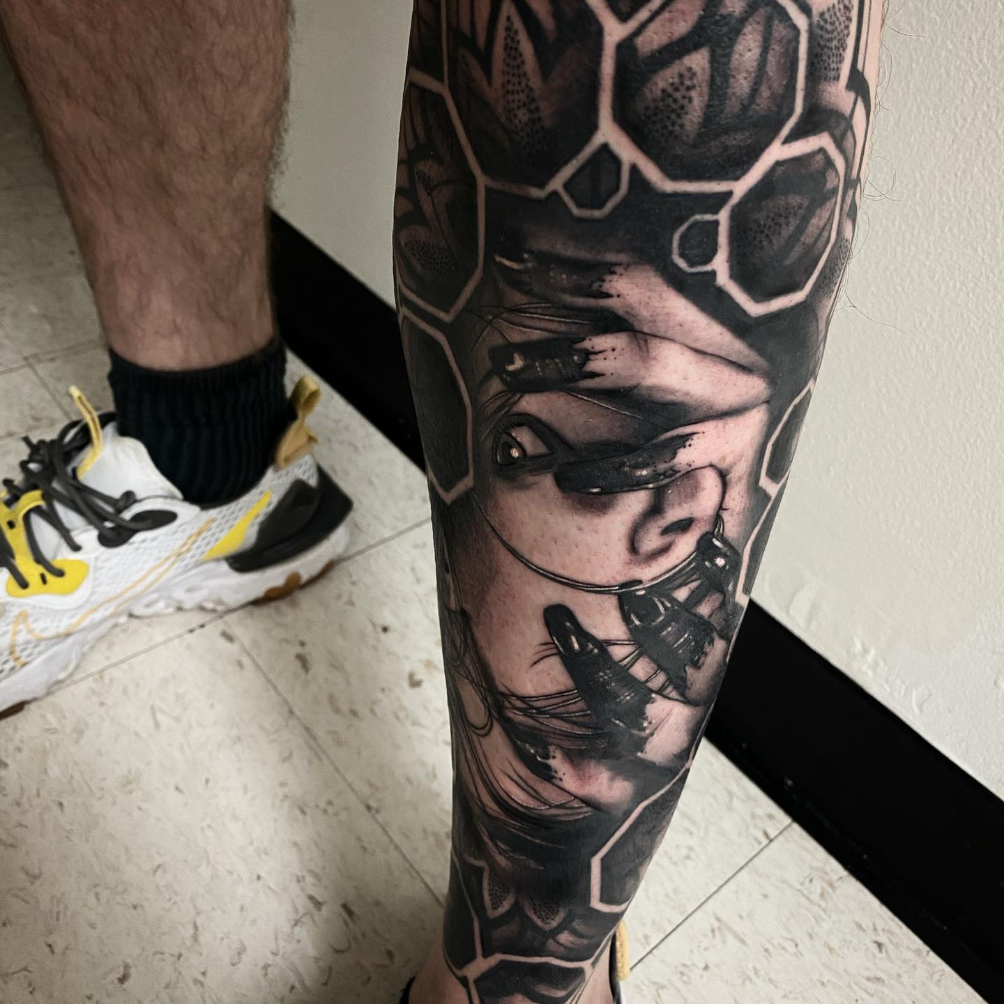 Cyborg face realism tattoo on the forearm by Dale DeVille