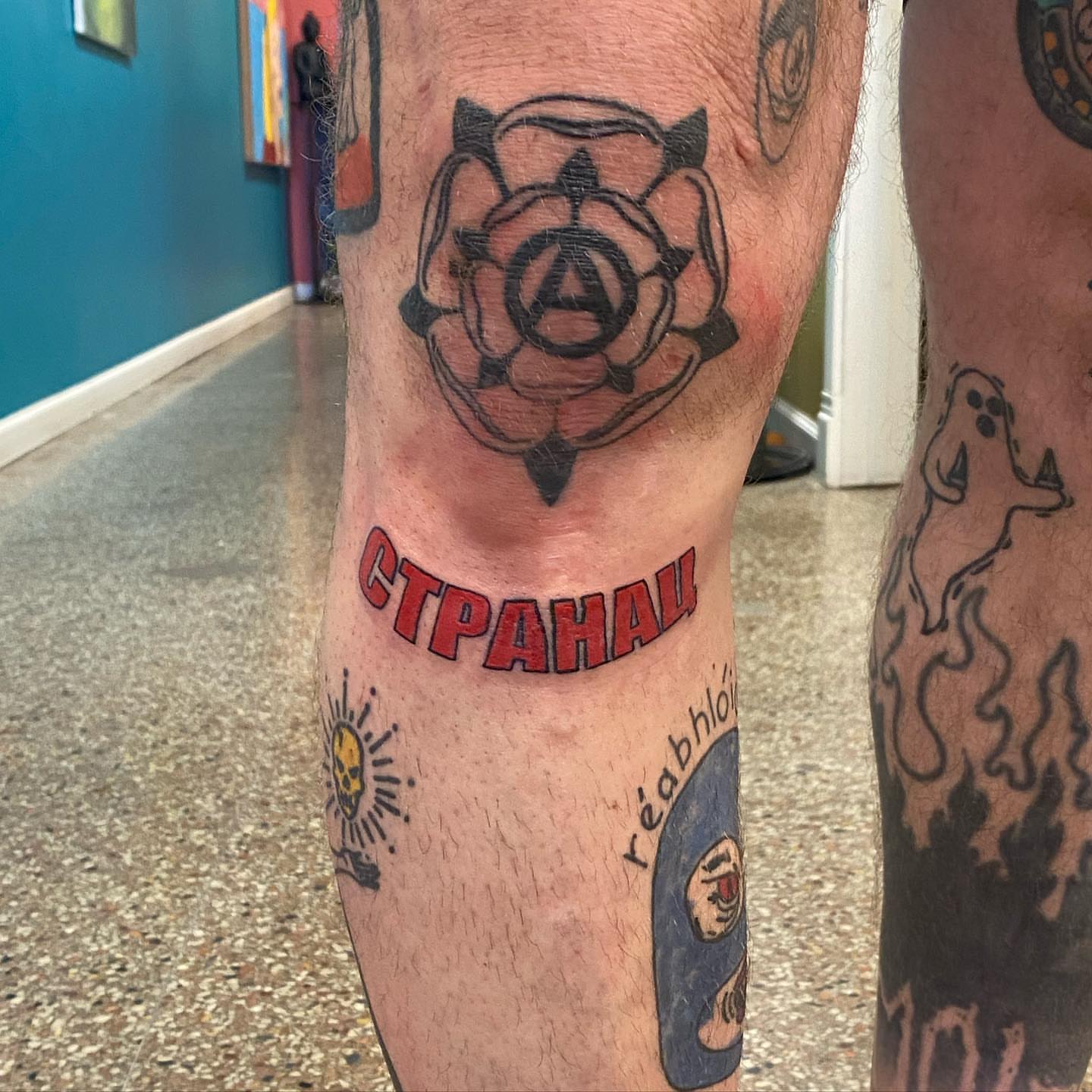Rose with anarchy symbol American traditional tattoo on the leg by Sally Darling