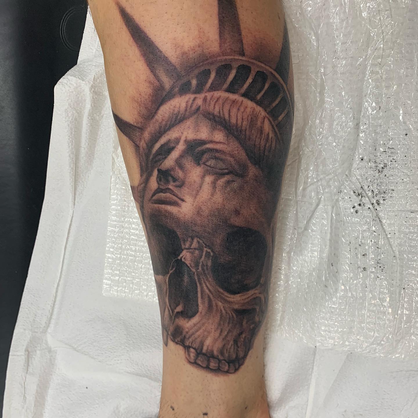 Statue of liberty skull realism tattoo on the forearm by Trevor Sibary