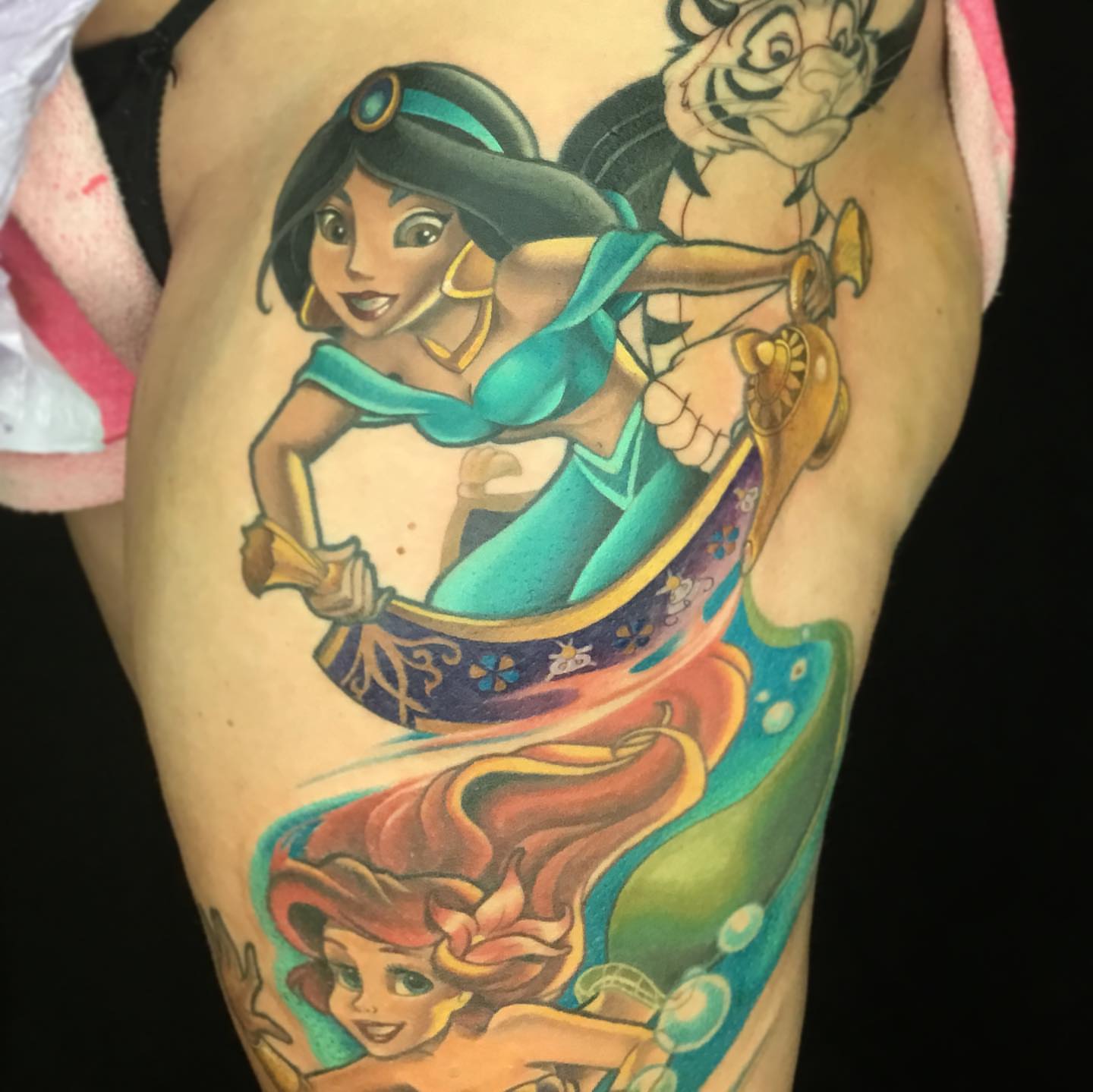Princess jasmine and genie lamp illustrative tattoo on the thigh by Ariel Robinson