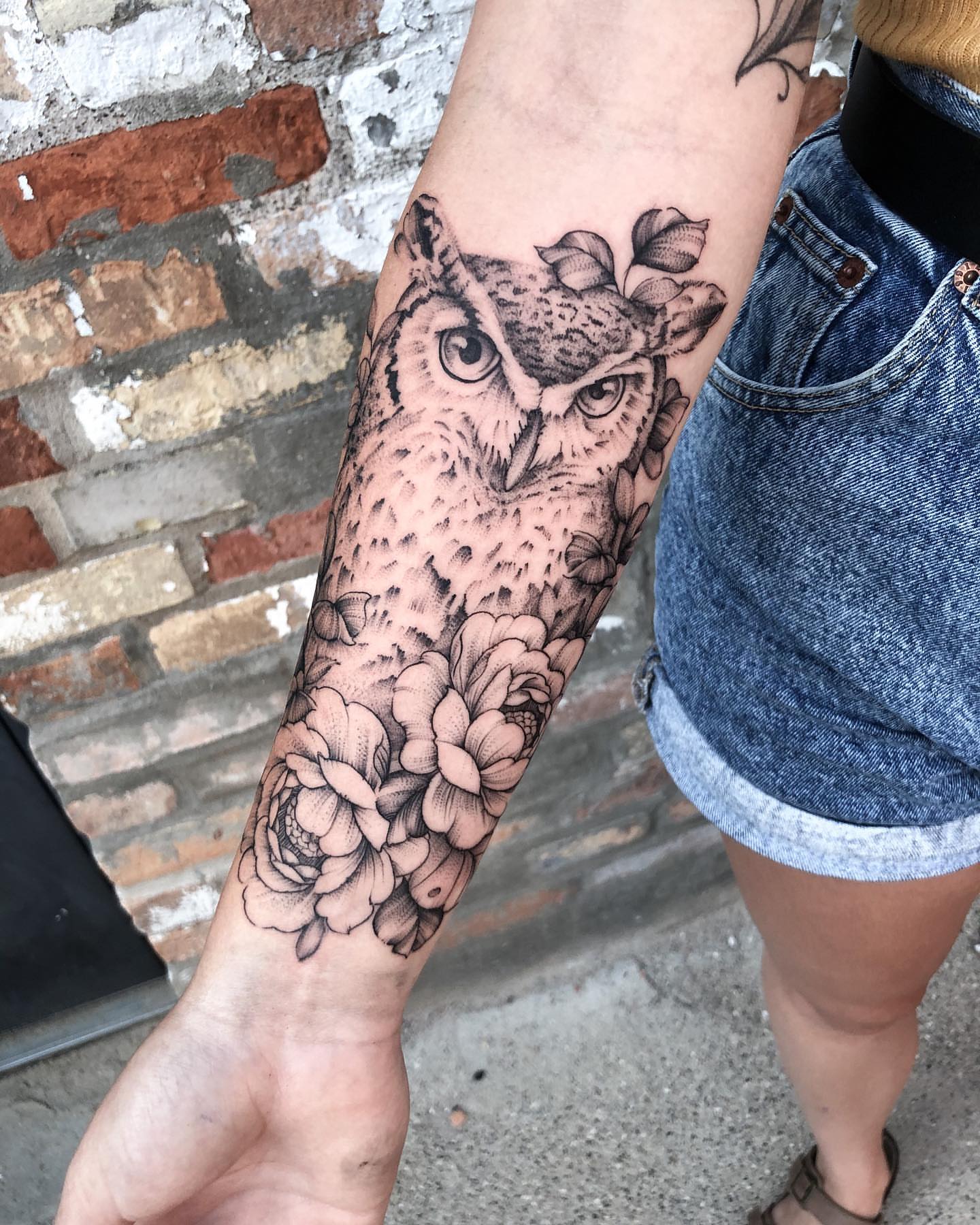 Owl and flowers realism tattoo on the forearm by Michigan Tattoo Artist
