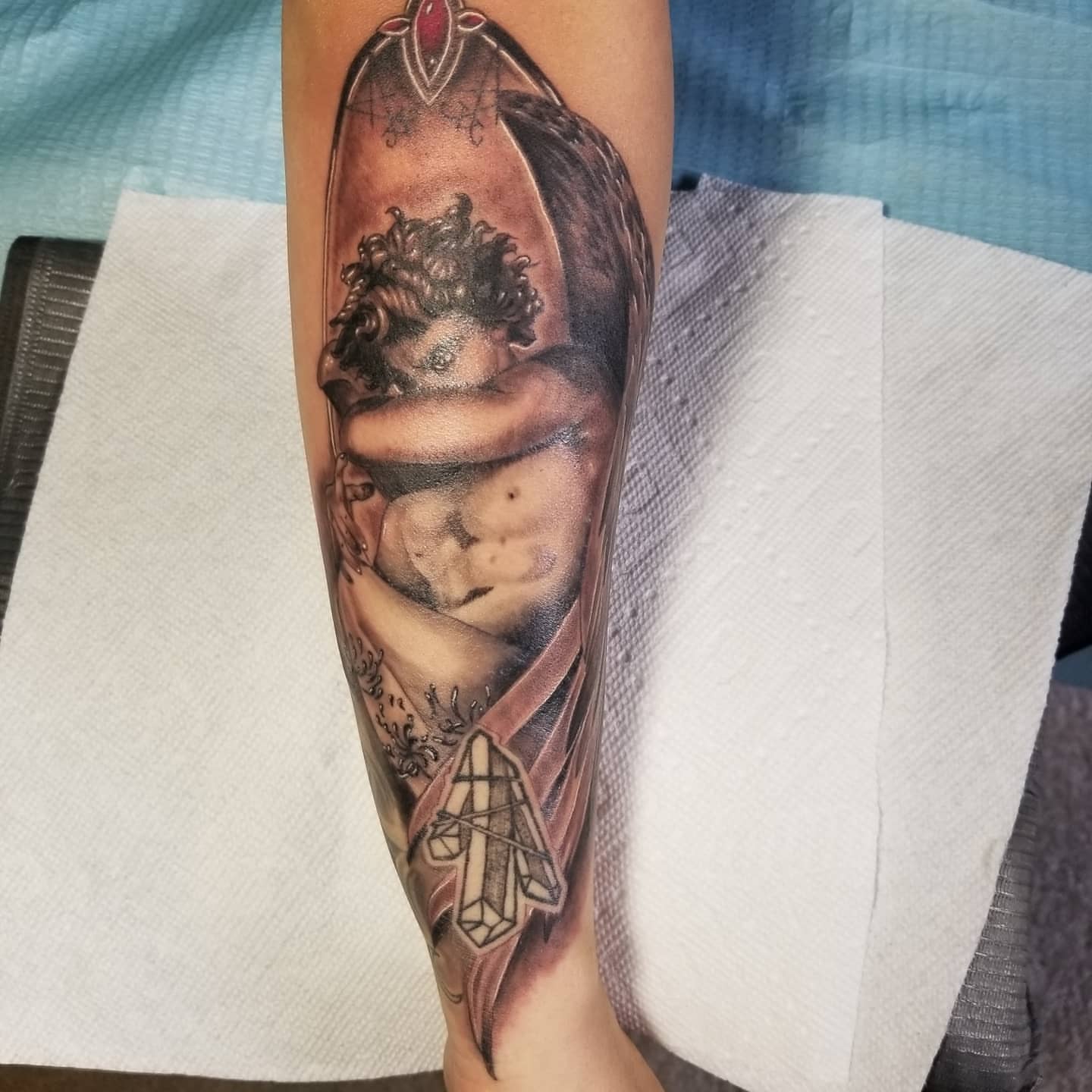 Man with crown realism tattoo on the forearm by Miguel-C, Houston, Texas