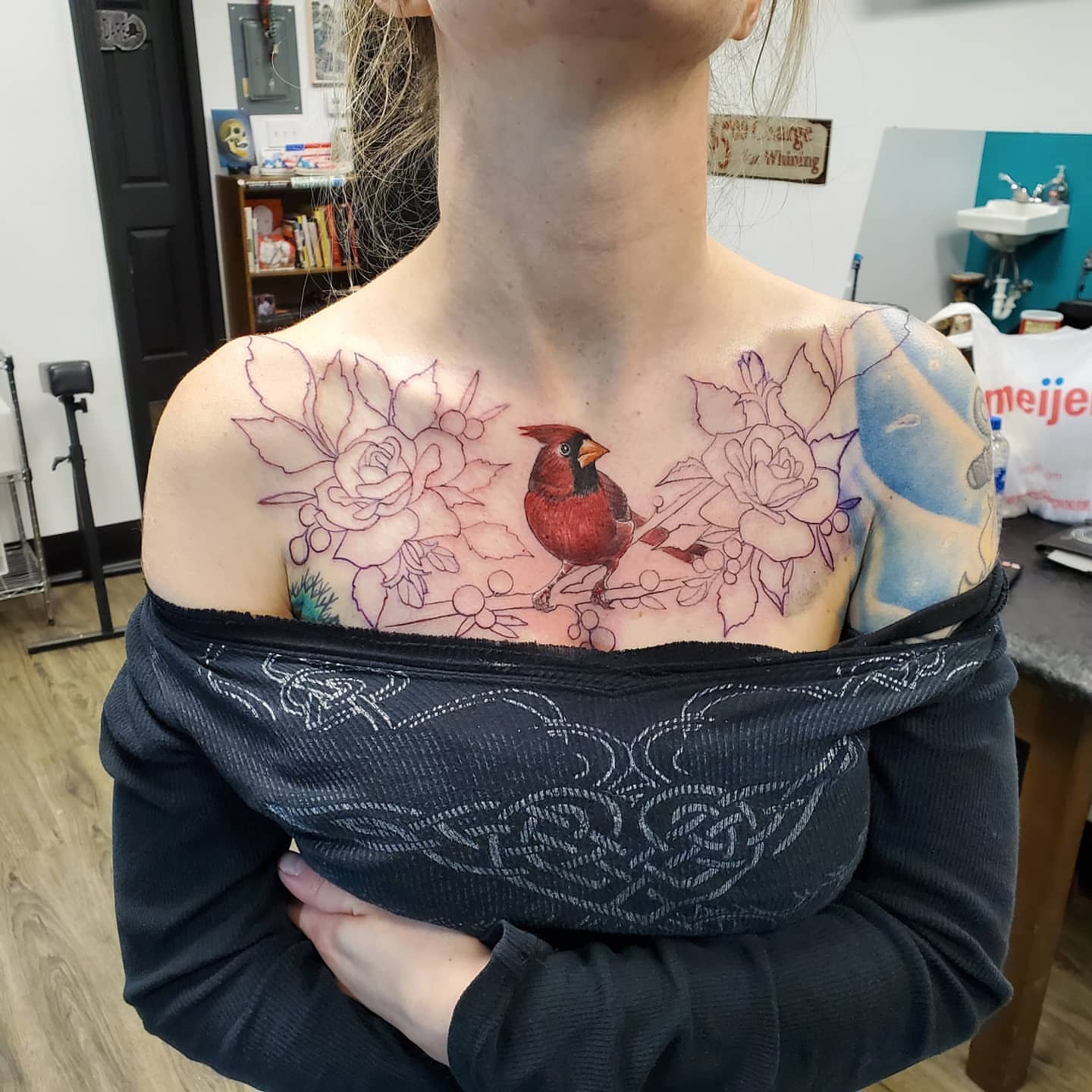 Cardinal and floral realism tattoo on the chest by @stevison15