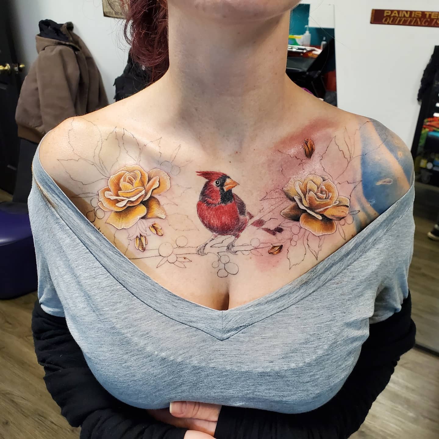 Cardinal and roses realism tattoo on the chest by @stevison15