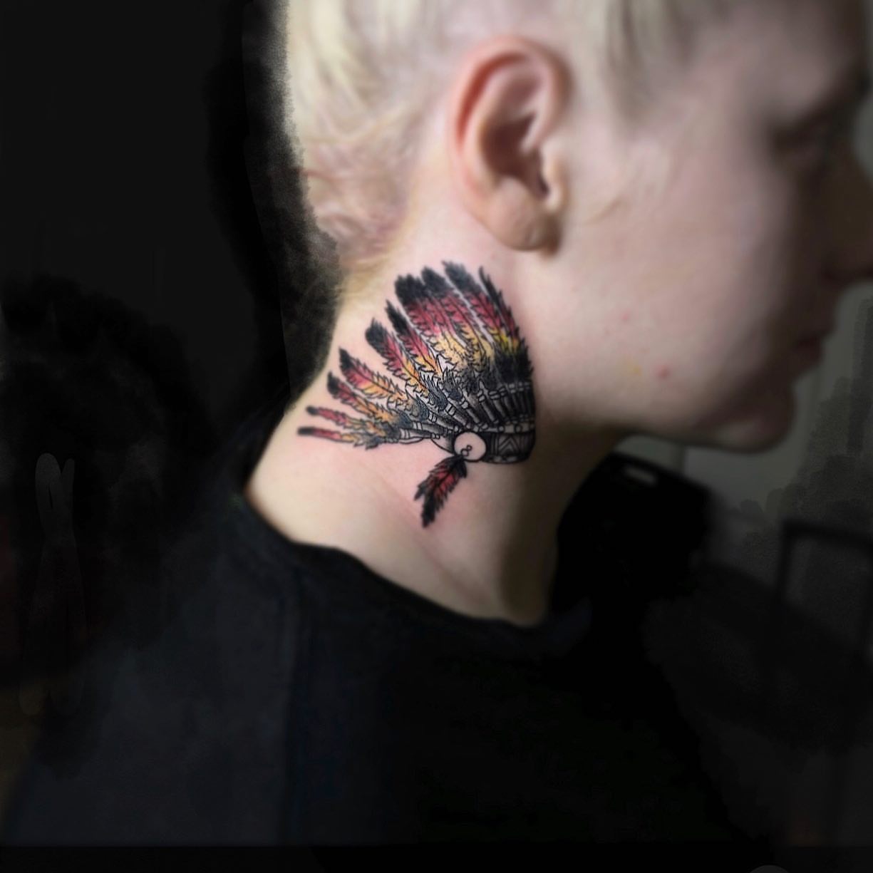 Native headdress American traditional tattoo on the neck by Syd Cheyenne