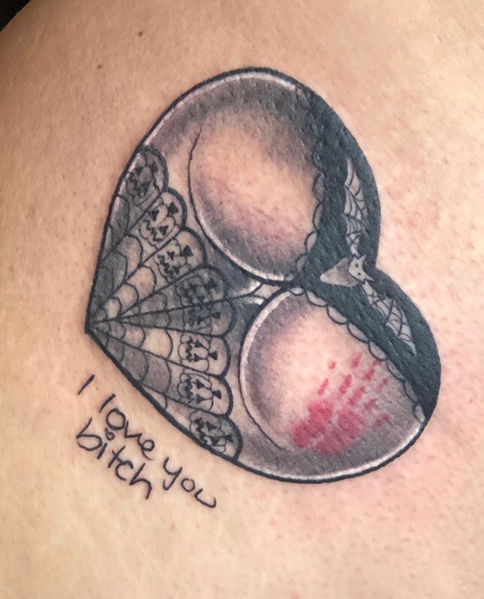 Heart with lace and handprint tattoo on the thigh by Chris