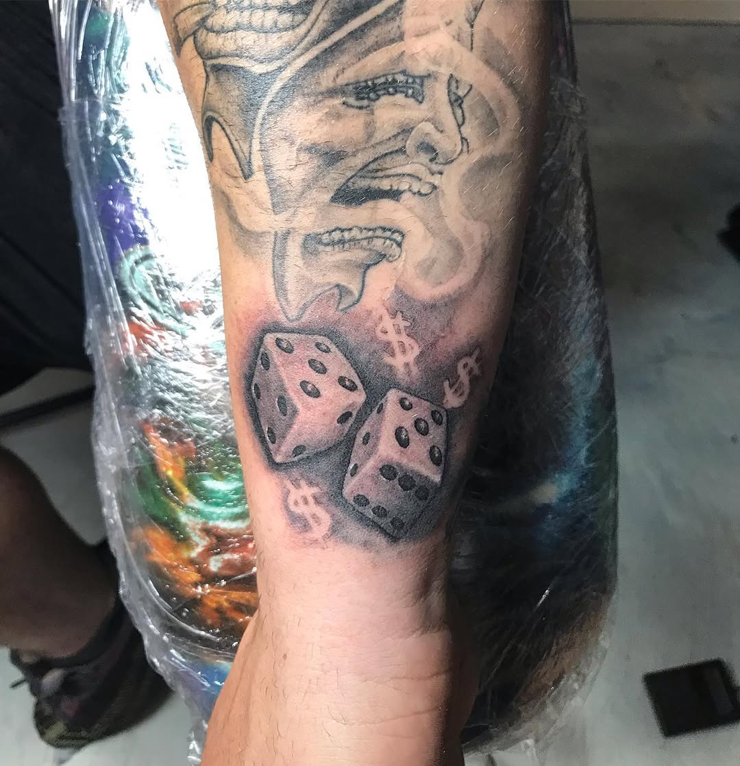 Dice and face realism tattoo on the forearm by Chris