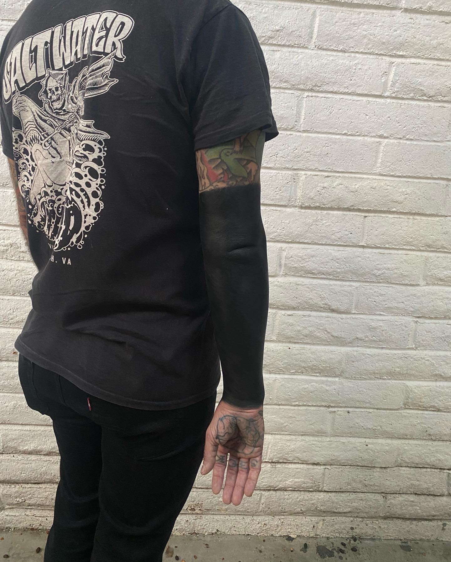 Skeleton riding horse American traditional tattoo on the upper arm by Mark Walker