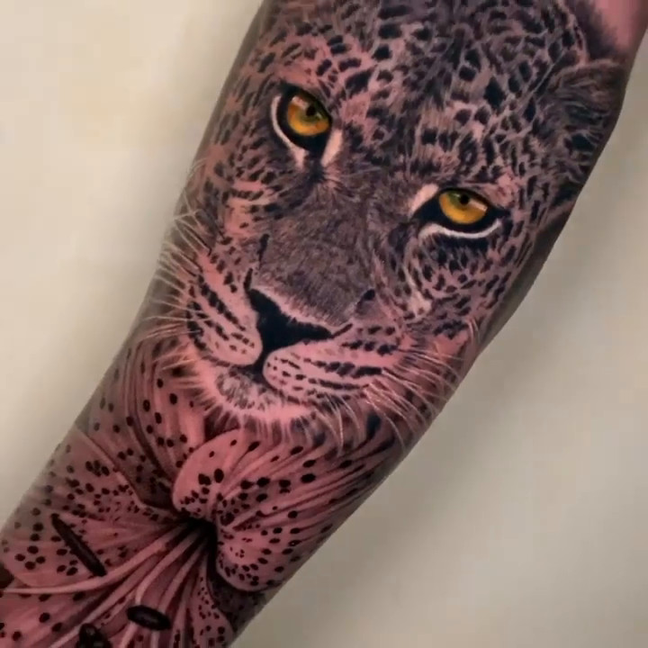 Leopard face with flowers realism tattoo by Alan Delarosa