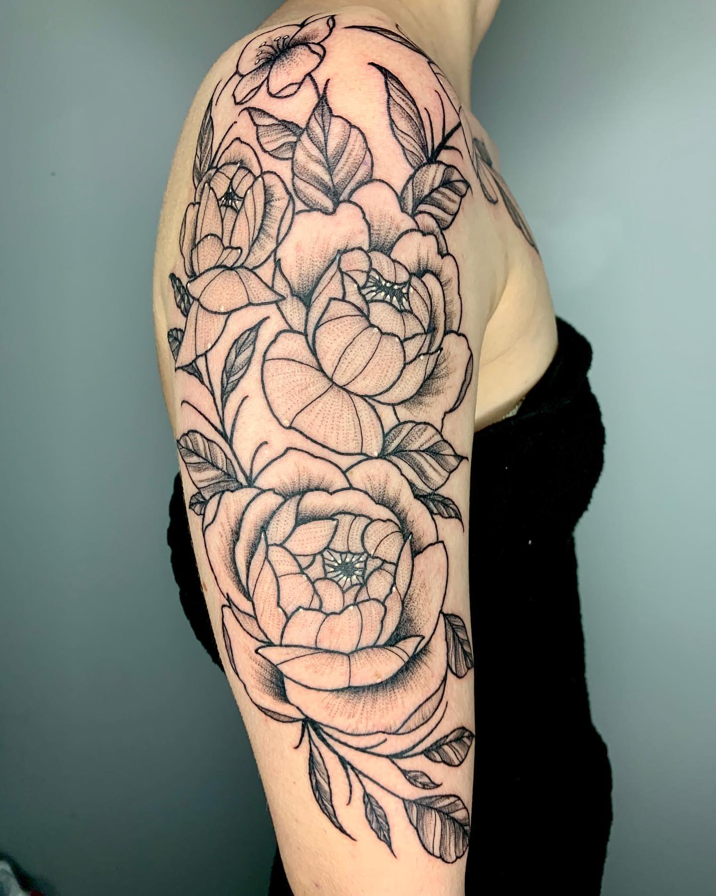 Floral bouquet dotwork tattoo on the upper arm by Luis Torres, Harrison, New Jersey