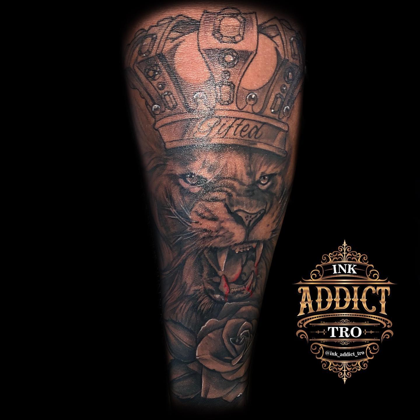 Lion wearing crown realism tattoo on the forearm by Trocon Talhouk