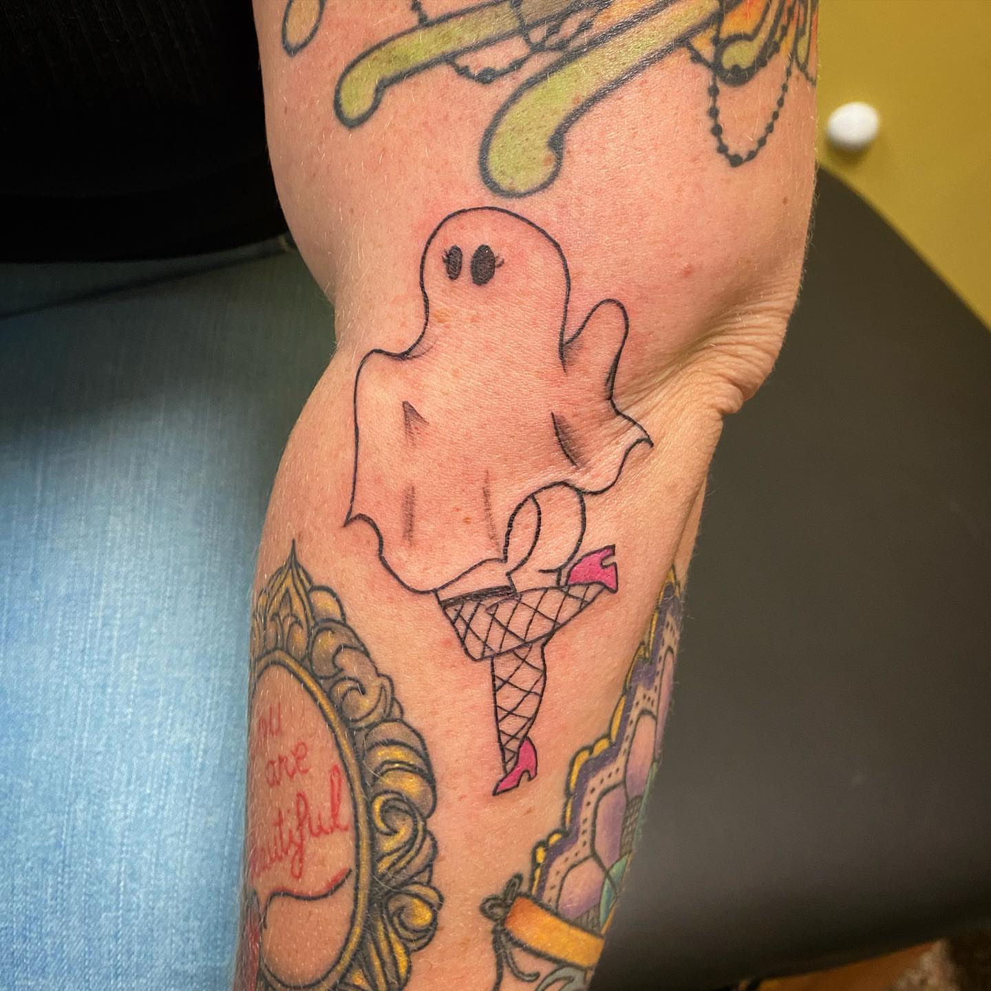 Ghost in lingerie American traditional tattoo on the forearm by Sally Darling