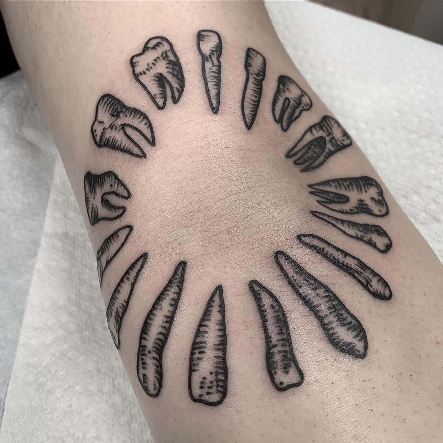 Teeth black and grey tattoo on the forearm by Pat Moser