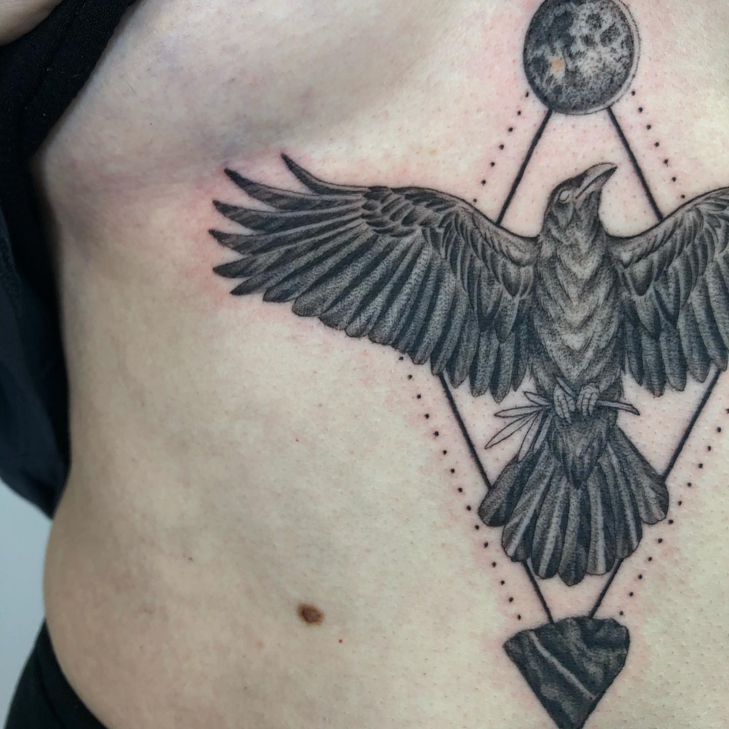 Crow geometric tattoo on the ribs by @jettaturas, New City, New York