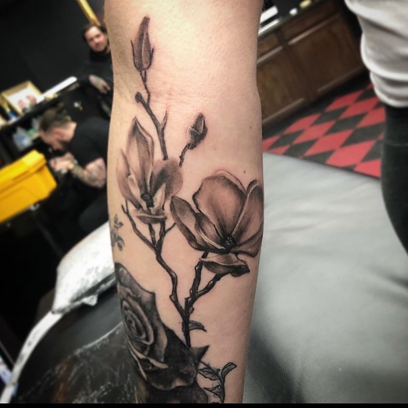 Magnolia flowers realism tattoo on the forearm by Caitlin Curtis Tattoos & Booking, Dayton, Ohio