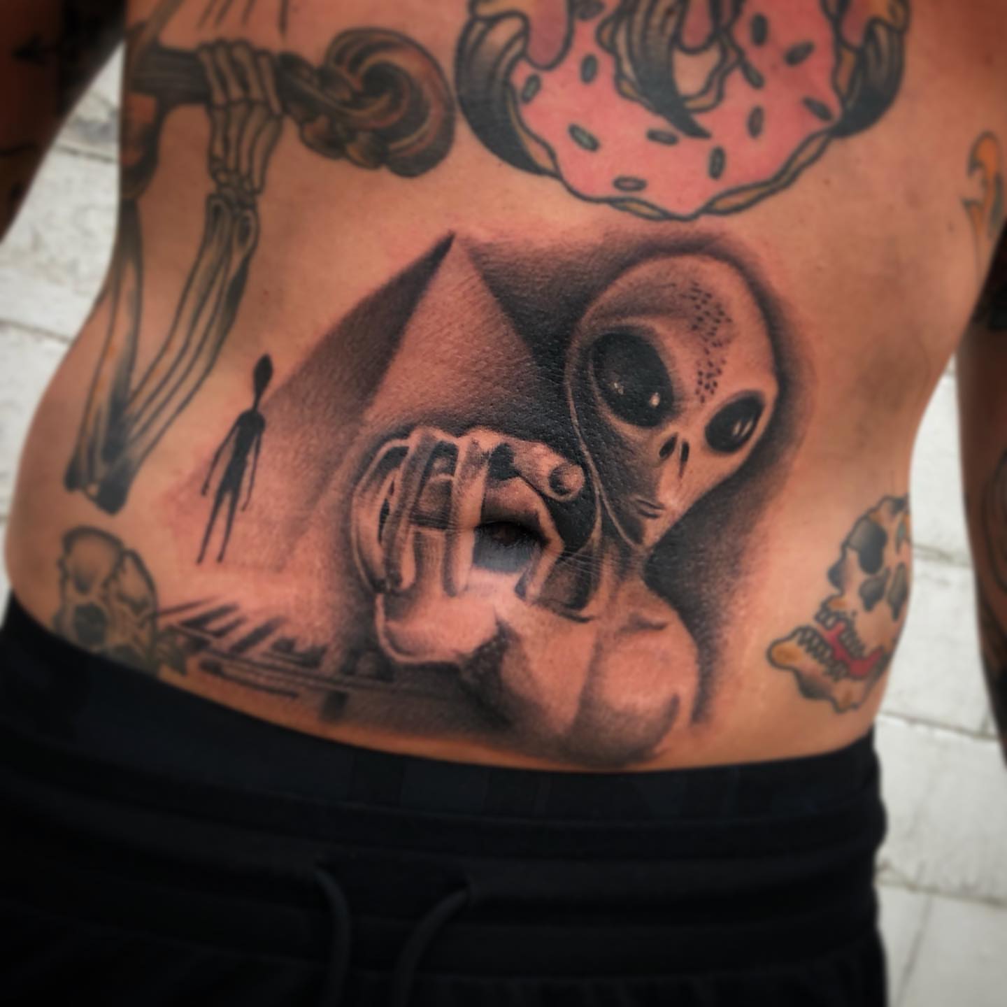 Alien abduction realism tattoo on the ribs by Nick Jones (Buttonsandfaders)