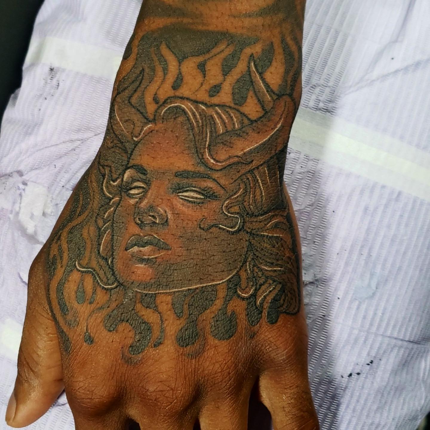 Woman with horns American traditional tattoo on the hand by Artfabn