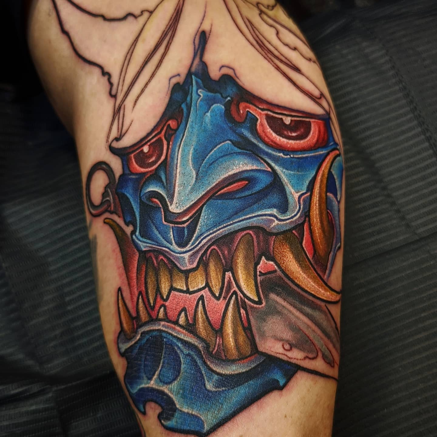 Demon mask dark realism tattoo on the forearm by Matt Driscoll