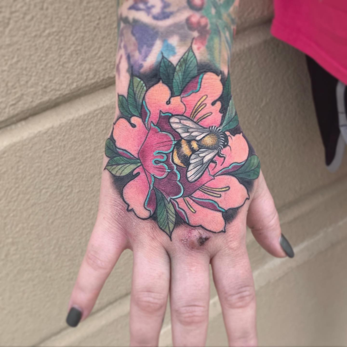 Flower and bee American traditional tattoo on the hand by Paul Hicks