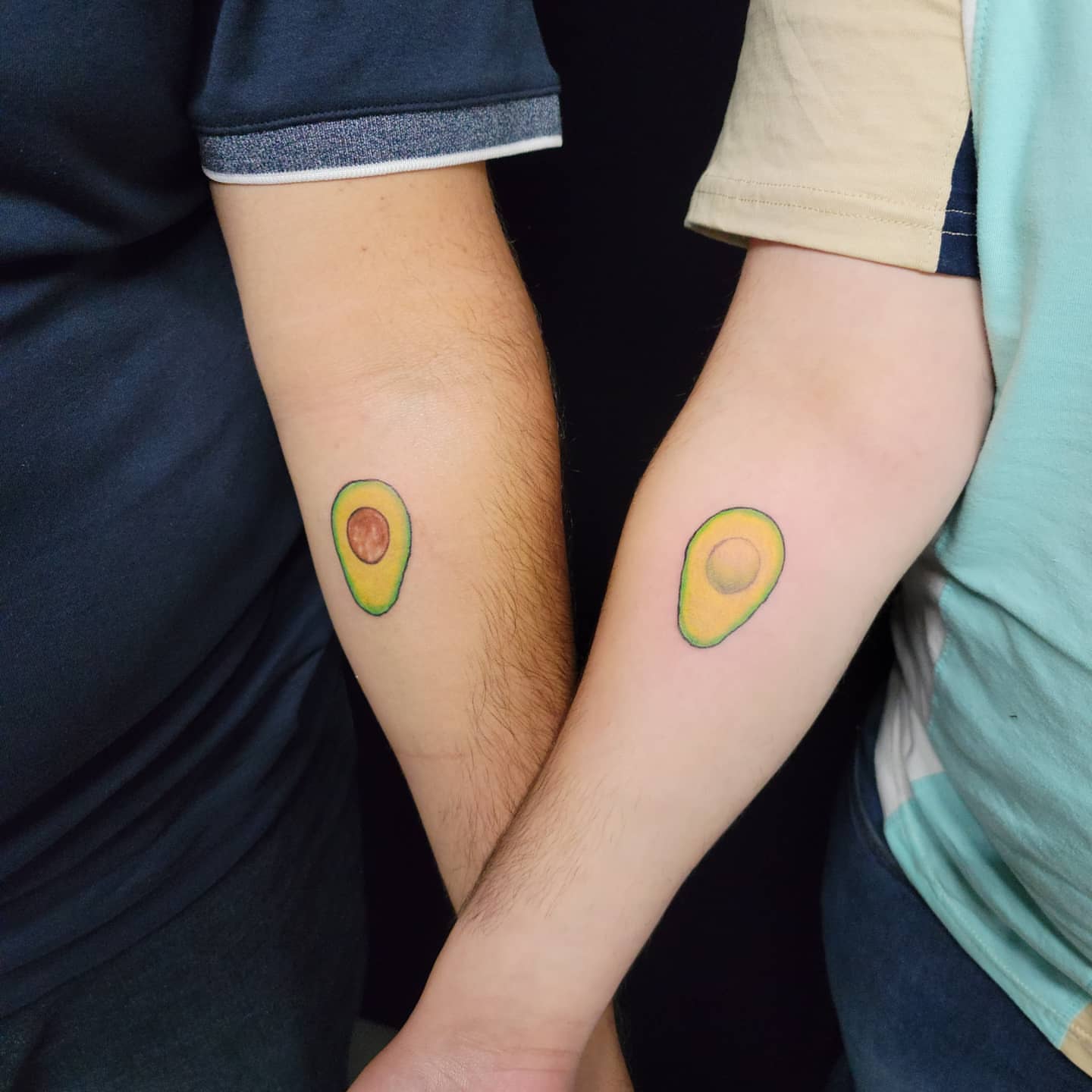 Avocado halves realism tattoo on the forearm by Eddy
