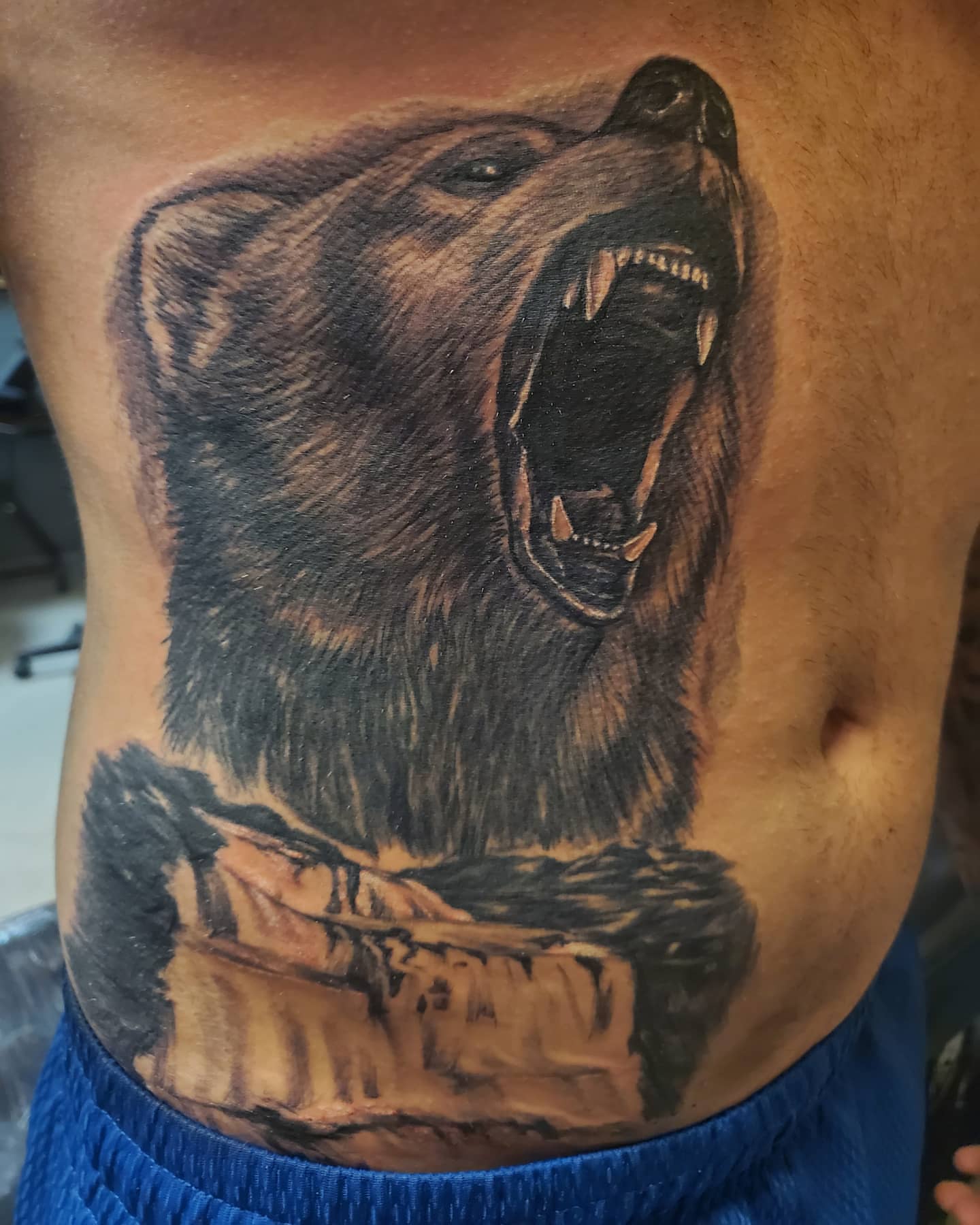 Roaring bear realism tattoo on the ribs by Anthony Coleman, Midland, Texas